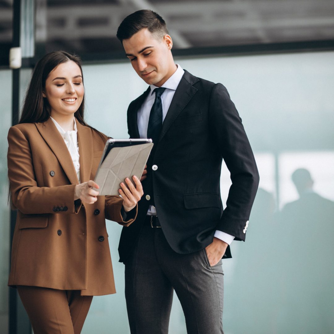 Male and female business people working on tablet in office